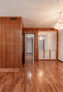 Empty room with Varnished wood mural mirrors Crystal chandelier Matching Parquet Floors